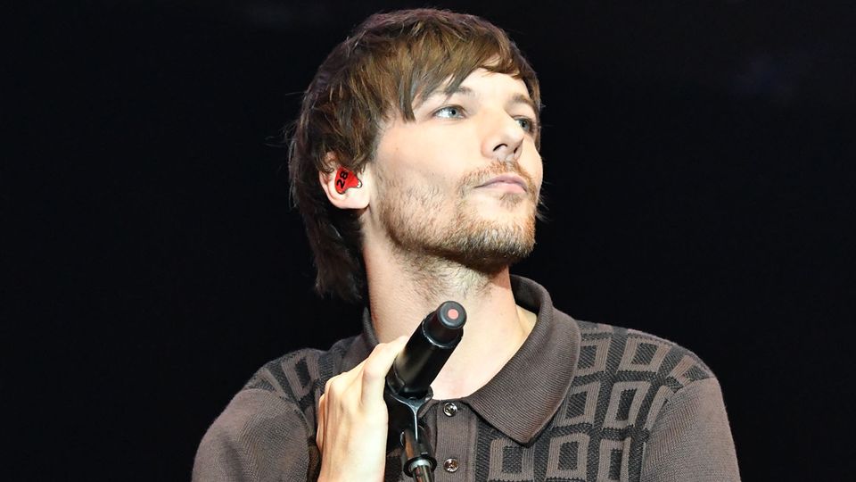 Louis Tomlinson of One Direction performs live during the X Factor