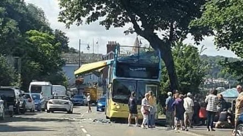 bus with missing roof after crashing into tree