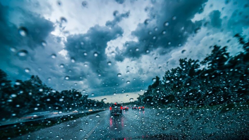 Cars on the road in heavy rain and strong winds