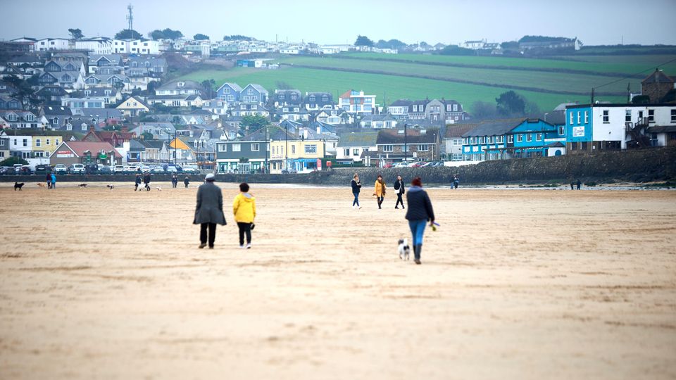 People walking on Perranporth beach