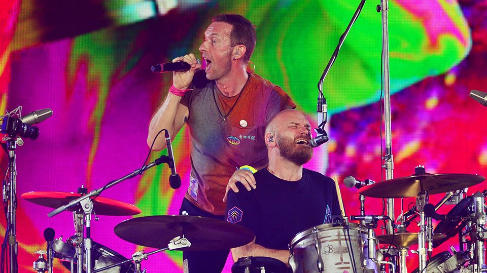 Will Champion of Coldplay performs on stage at Wembley Stadium