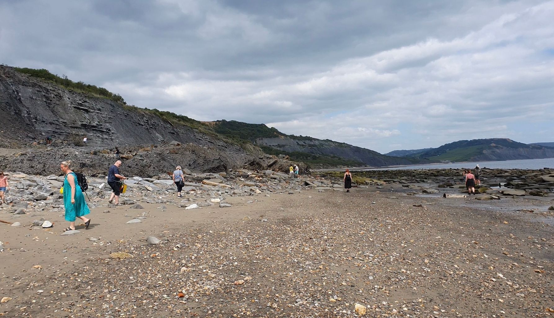 Material from disused landfill site falling onto Dorset beach during landslips