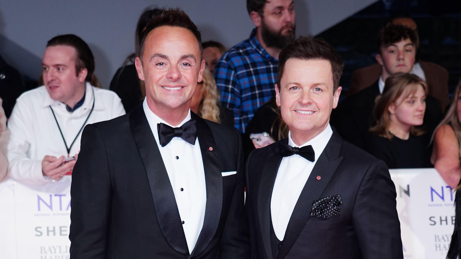 Ant and Dec posing for a photo together on the red carpet at the NTA Awards wearing black tuxedos