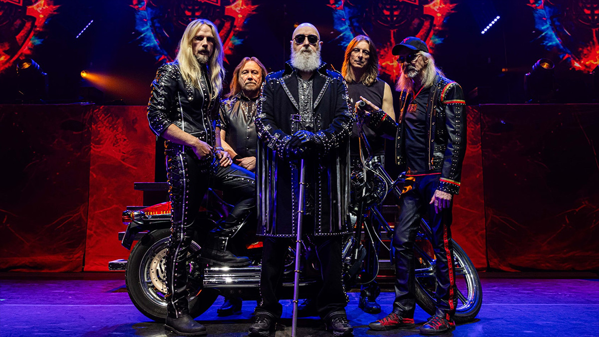 Judas Priest standing in front of a motorbike
