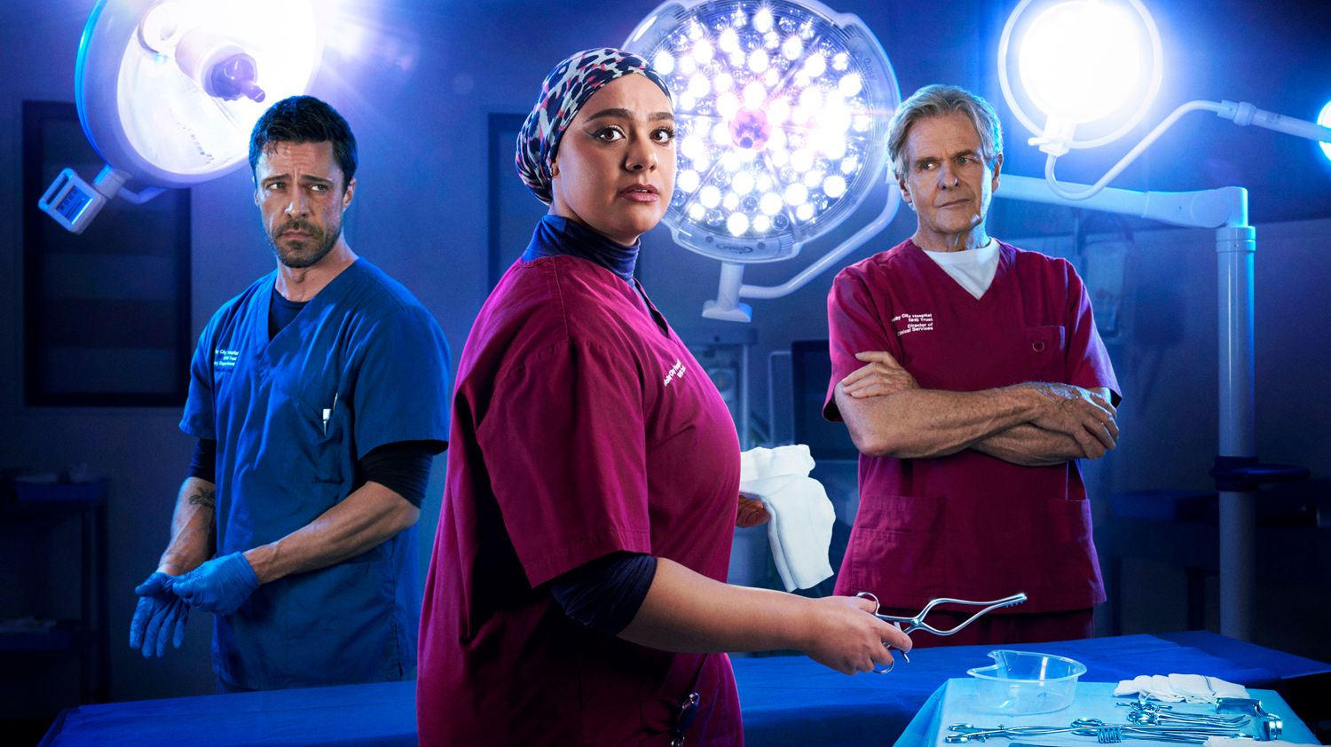 Actors Olly Rix, Sarah Seggari and Robert Bathurs as Flynn Byron, Rida Amaan and Russell Whitelaw in BBC drama Casualty