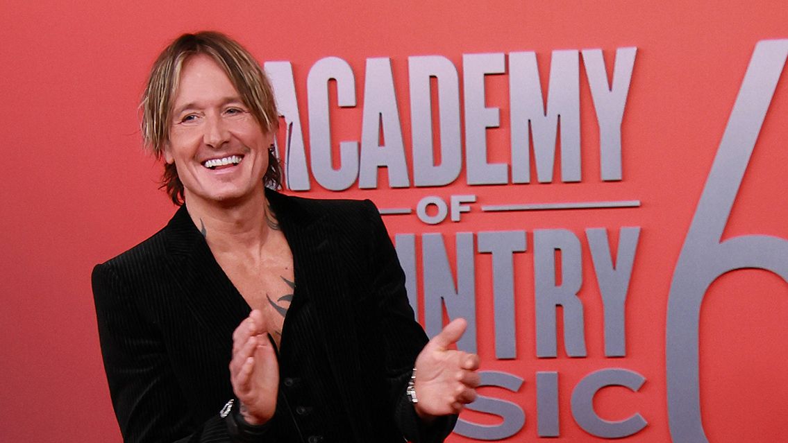 Keith Urban smiling on the 60th Academy of Country Music Awards red carpet
