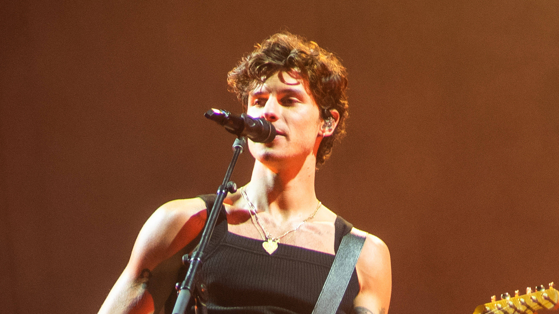Tate McRae performing live on stage at a concert in 2026