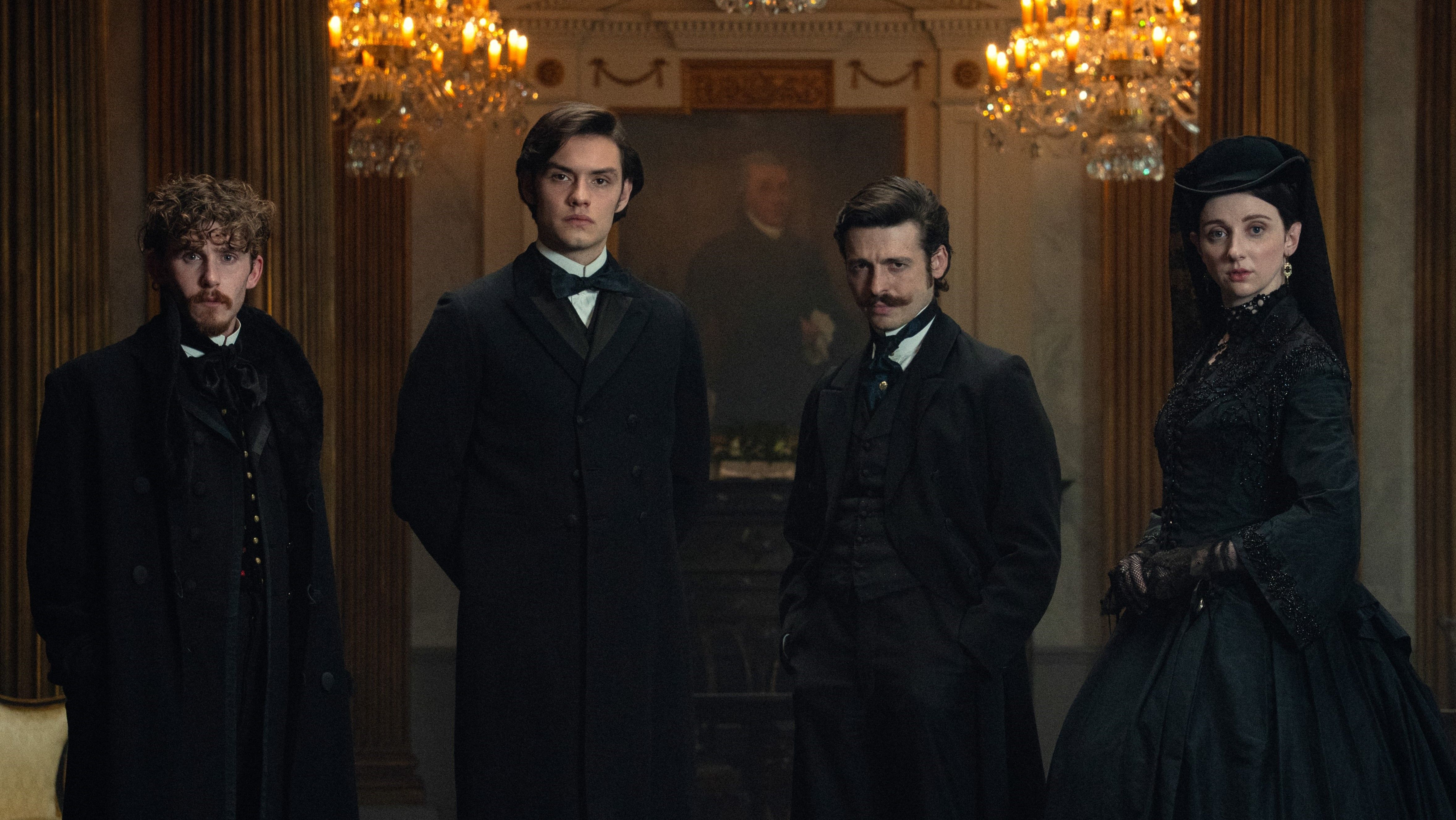House of Guinness cast in costume stood in a dark room facing the camera