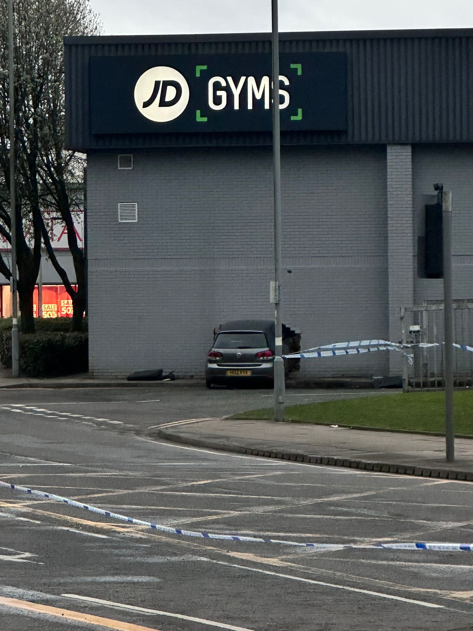 Two injured as car ploughs into JD Gyms building in Bury