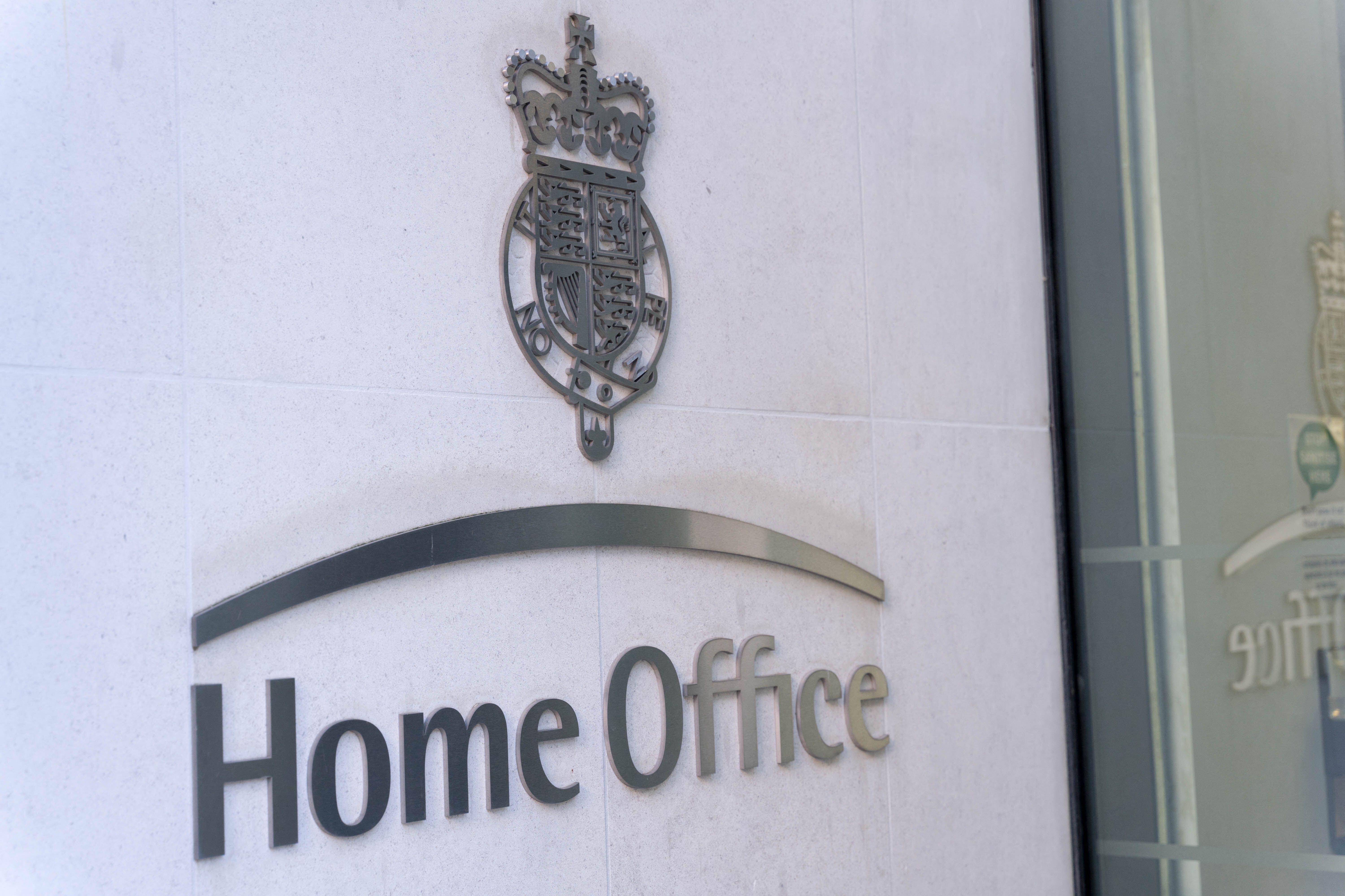 Home Office silver signage on grey brick wall